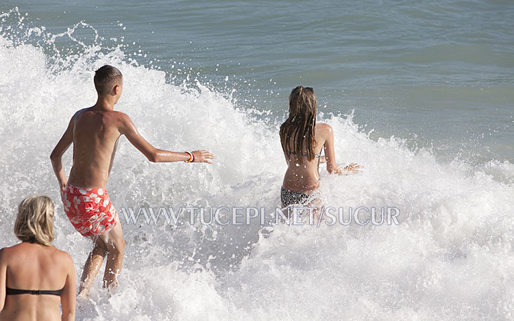 children playing in sea waves
